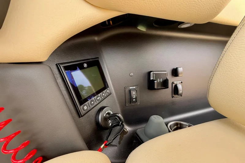 Slide: The Image of Control panel of 2026 Chris-Craft Sportster 28 with display and switches. - 27