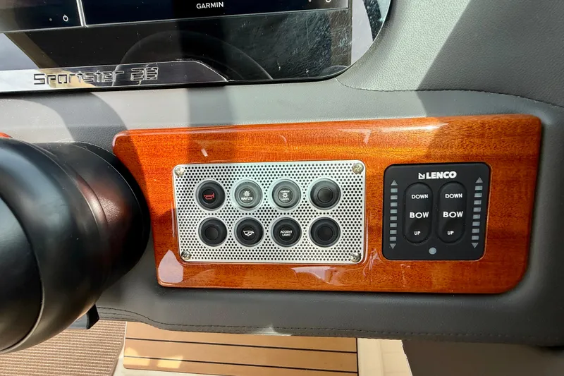 Slide: The Image of Control panel of 2026 Chris-Craft Sportster 28 with Lenco trim tab switches. - 28