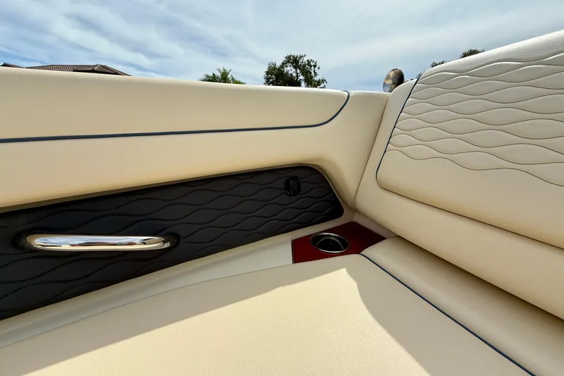 Slide: The Image of 2026 Chris-Craft Sportster 28 interior with elegant beige and black leather upholstery. - 35