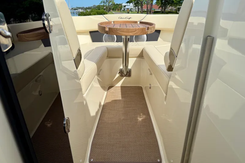 Slide: The Image of 2026 Chris-Craft Sportster 28 interior with beige seating and wooden table. - 39
