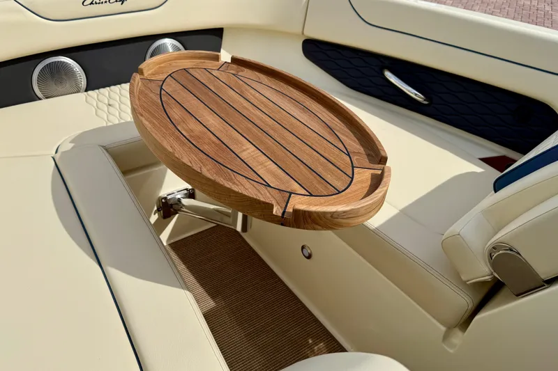 Slide: The Image of Luxurious interior of 2026 Chris-Craft Sportster 28 with elegant wooden table and seating. - 41