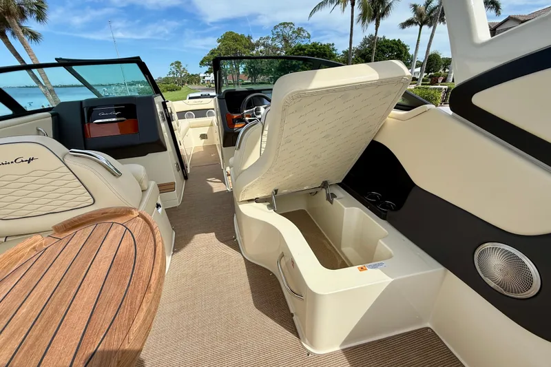 Slide: The Image of 2026 Chris-Craft Sportster 28 interior with open storage, luxurious seating, and wooden accents. - 45