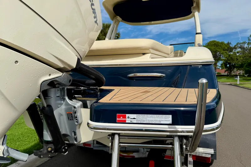 Slide: The Image of 2026 Chris-Craft Sportster 28 boat with Mercury engine, rear view on a sunny day. - 49