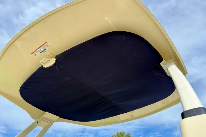 Slide: The Image of 2026 Chris-Craft Sportster 28 boat canopy against a clear blue sky. - 50