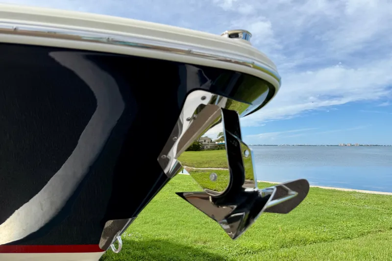 Slide: The Image of 2026 Chris-Craft Sportster 28 boat with shiny anchor, near serene waterfront. - 51