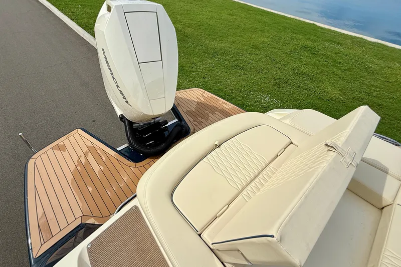 Slide: The Image of 2026 Chris-Craft Sportster 28 with Mercury outboard engine, featuring elegant teak decking. - 7