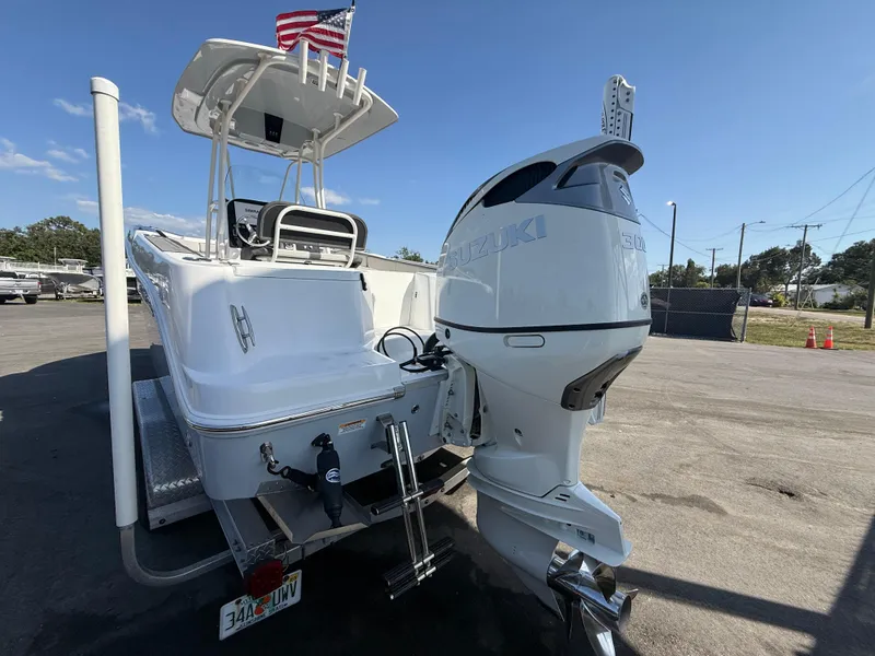 Slide: The Image of 2022 Aquasport 2300 Center Console boat with Suzuki outboard motor, parked on a trailer. - 29
