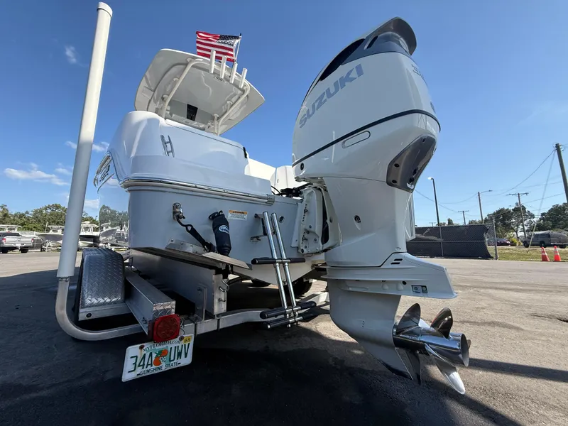 Slide: The Image of 2022 Aquasport 2300 Center Console boat with Suzuki outboard motor on trailer. - 30