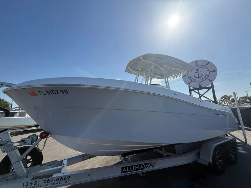 Slide: The Image of 2022 Aquasport 2300 Center Console boat on trailer under clear sky. - 33