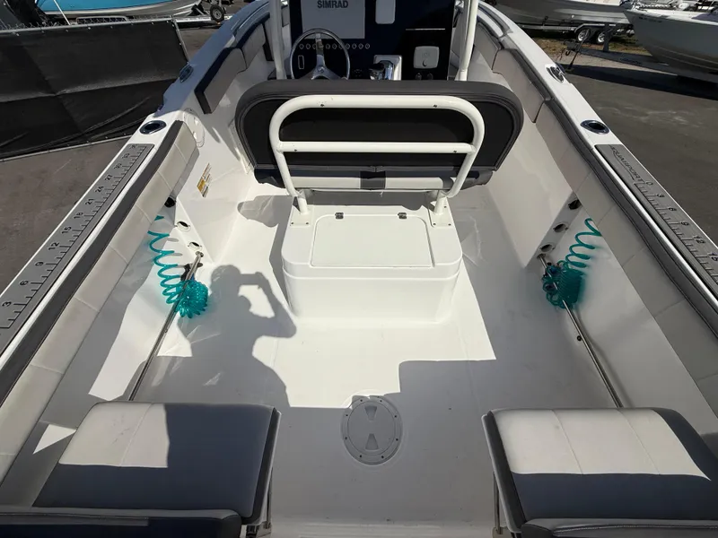 Slide: The Image of 2022 Aquasport 2300 Center Console boat interior with seating and storage. - 36