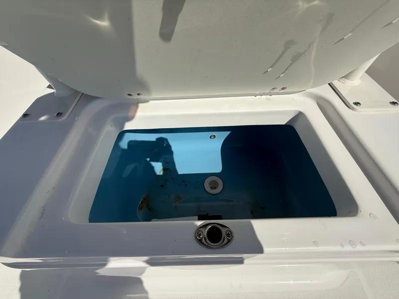 Slide: The Image of 2022 Aquasport 2300 Center Console livewell with open lid, showcasing interior. - 38
