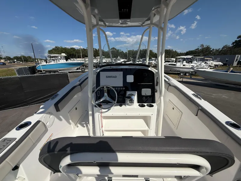Slide: The Image of 2022 Aquasport 2300 Center Console boat with modern dashboard and steering wheel. - 39