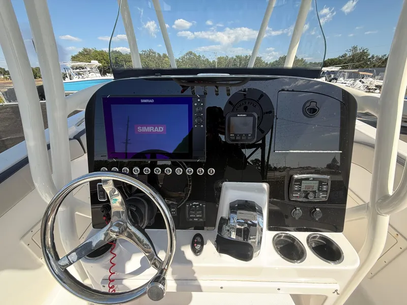 Slide: The Image of 2022 Aquasport 2300 Center Console dashboard with steering wheel and navigation display. - 42