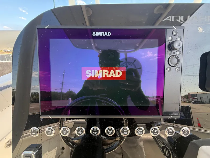 Slide: The Image of Simrad display on 2022 Aquasport 2300 Center Console boat dashboard. - 43