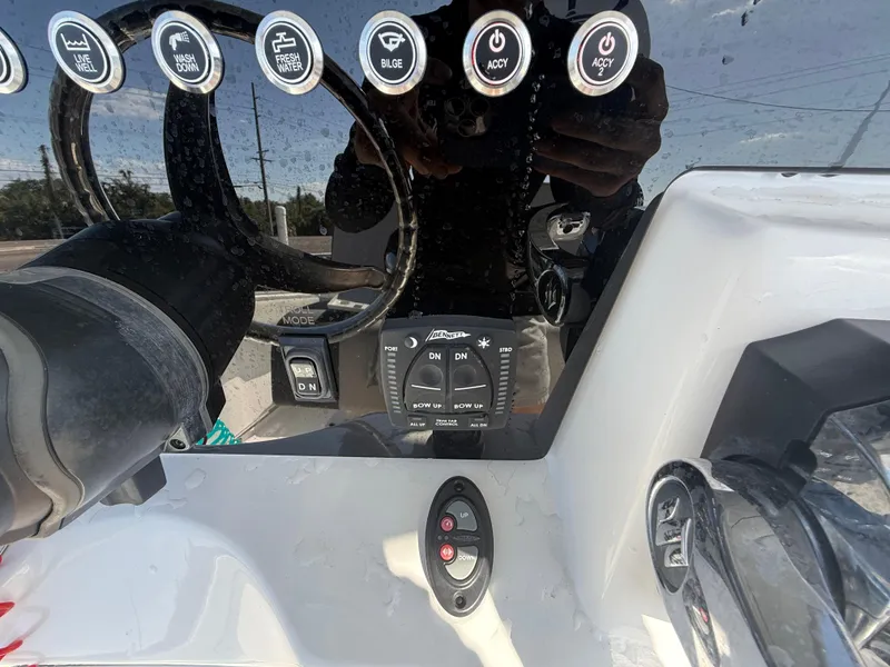 Slide: The Image of 2022 Aquasport 2300 Center Console dashboard with steering wheel and control buttons. - 44