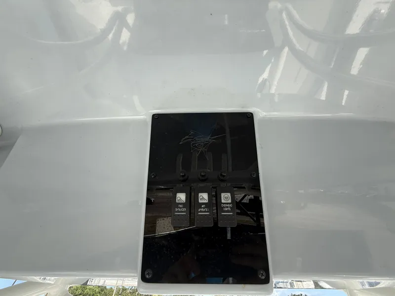 Slide: The Image of Control panel of 2022 Aquasport 2300 Center Console boat with switches. - 46