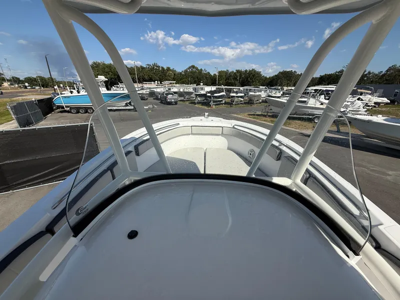 Slide: The Image of 2022 Aquasport 2300 Center Console boat, view from helm, in a marina setting. - 47