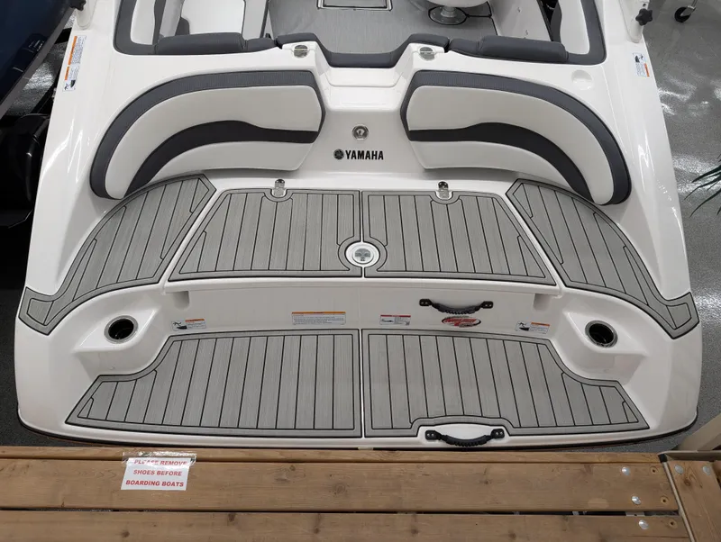 Slide: The Image of 2024 Yamaha AR195 boat deck with gray padding and seating area. - 3