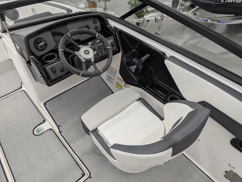 Slide: The Image of 2024 Yamaha Boats AR195 cockpit with steering wheel and captain's seat, featuring modern controls. - 6
