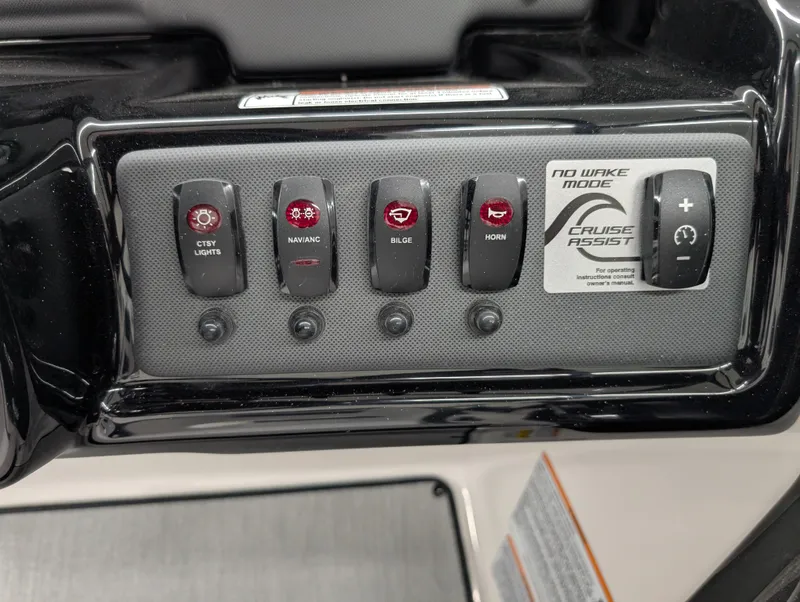 Slide: The Image of Control panel of 2024 Yamaha Boats AR195 featuring various switches and Cruise Assist. - 9