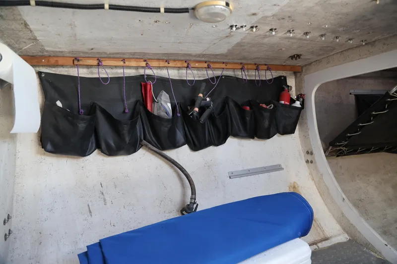 Slide: The Image of Interior of 1992 Catalina Capri 37 sailboat with organized storage pockets and blue cover. - 11