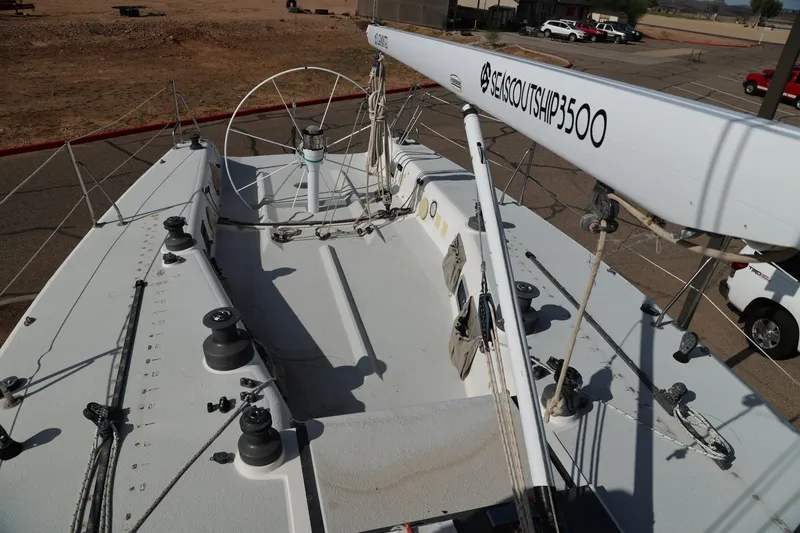 Slide: The Image of 1992 Catalina Capri 37 sailboat deck with rigging and winches in a parking area. - 17