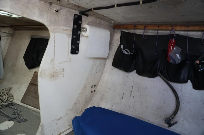 Slide: The Image of Interior of a 1992 Catalina Capri 37 sailboat with storage and paper towel holder. - 4