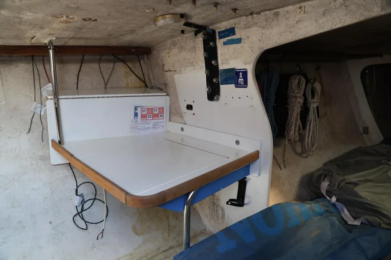Slide: The Image of Interior of a 1992 Catalina Capri 37 sailboat with a foldable table and storage area. - 5