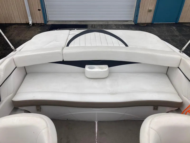 Slide: The Image of 2008 Four Winns H200 boat interior with white seating and cup holders. - 11