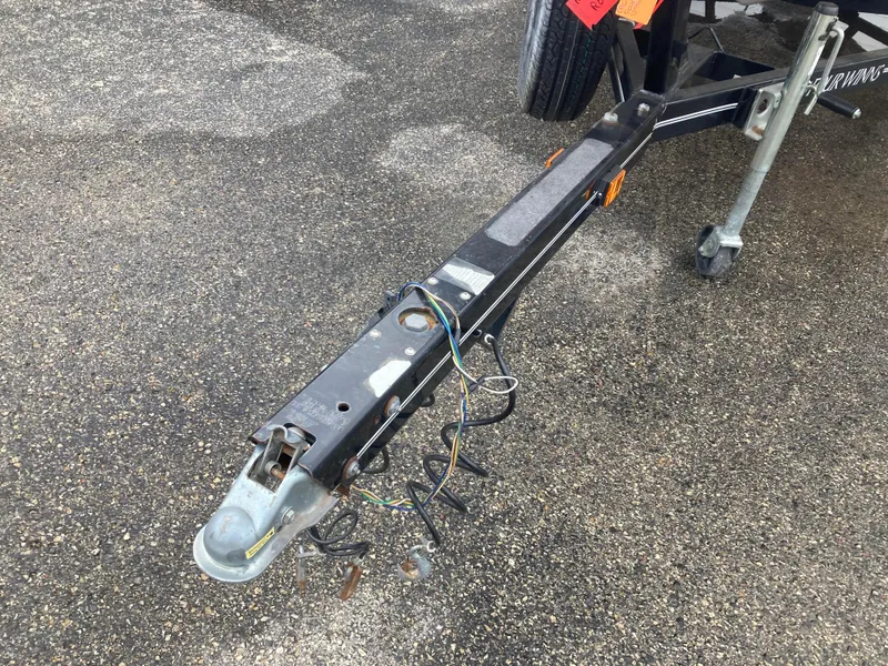 Slide: The Image of Trailer hitch of a 2008 Four Winns H200 boat on asphalt surface. - 14