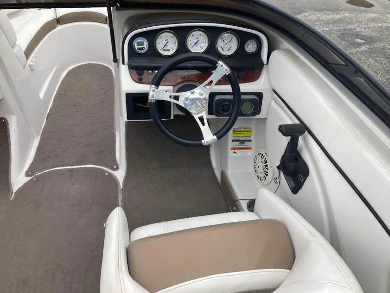 Slide: The Image of Interior of a 2008 Four Winns H200 boat, featuring steering wheel and dashboard controls. - 4