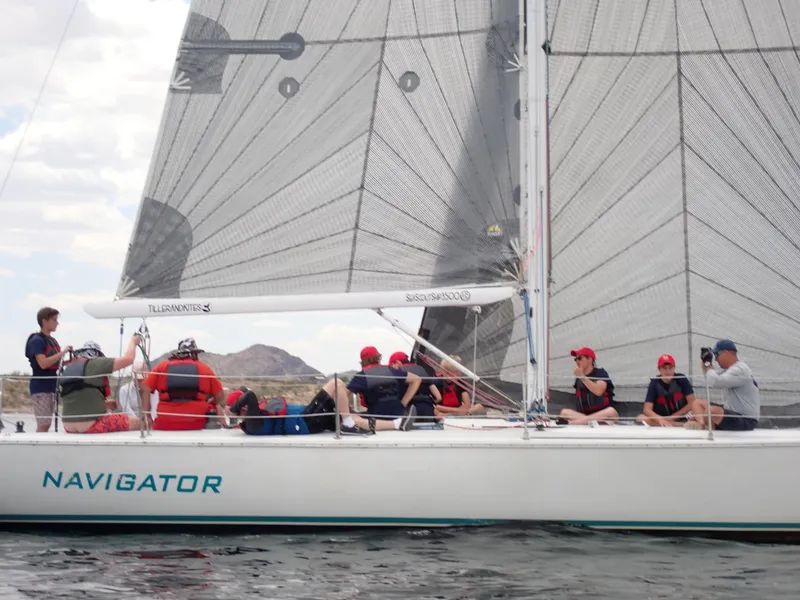 Slide: The Image of Sailors on a 1992 Catalina Capri 37 yacht named Navigator, sailing with large sails. - 13