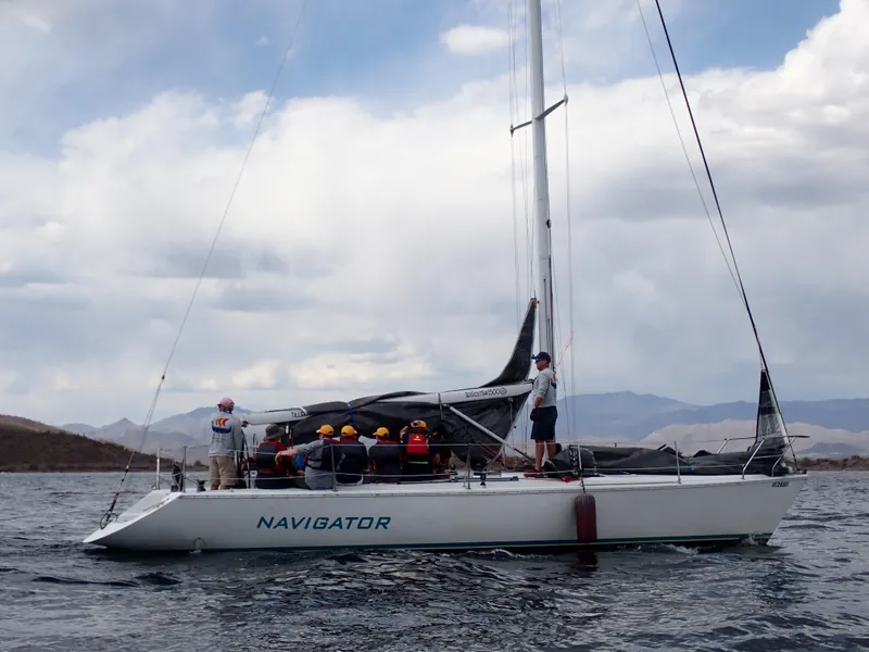Slide: The Image of Catalina Capri 37 sailboat on water, crew onboard, cloudy sky background, 1992 model. - 14