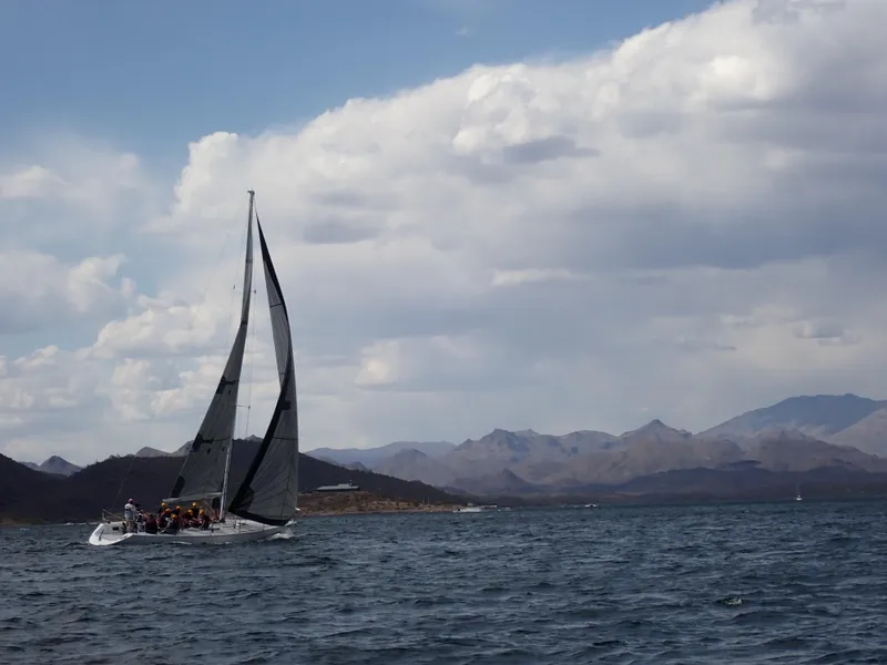 Slide: The Image of Sailboat Catalina Capri 37, 1992, gliding on water with mountainous backdrop. - 16