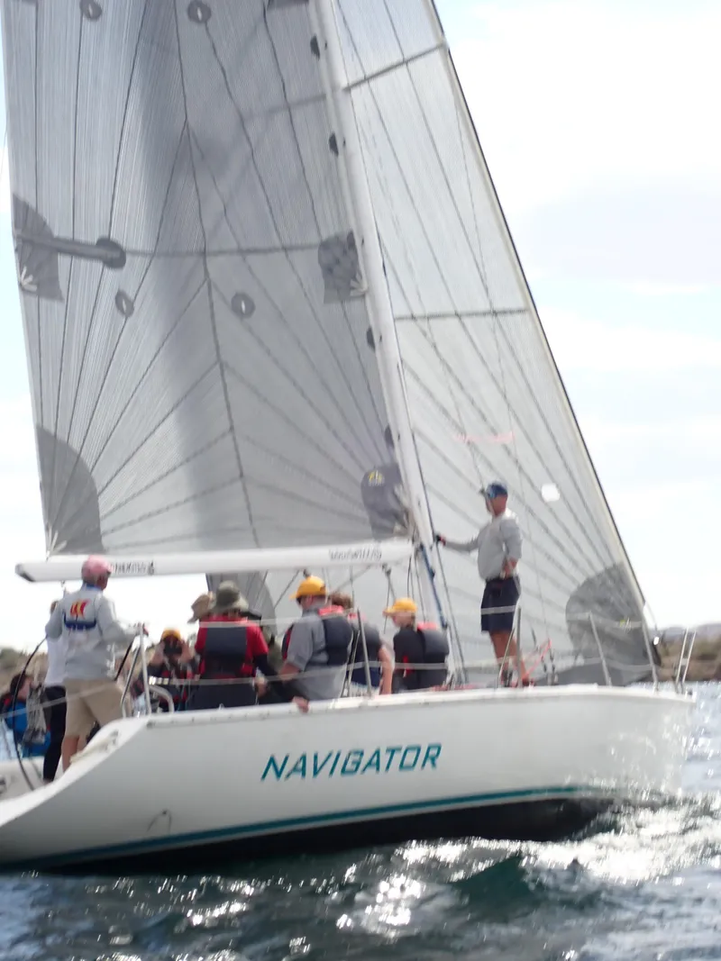 Slide: The Image of Sailboat "Navigator" Catalina Capri 37, 1992, with crew sailing on open water. - 17
