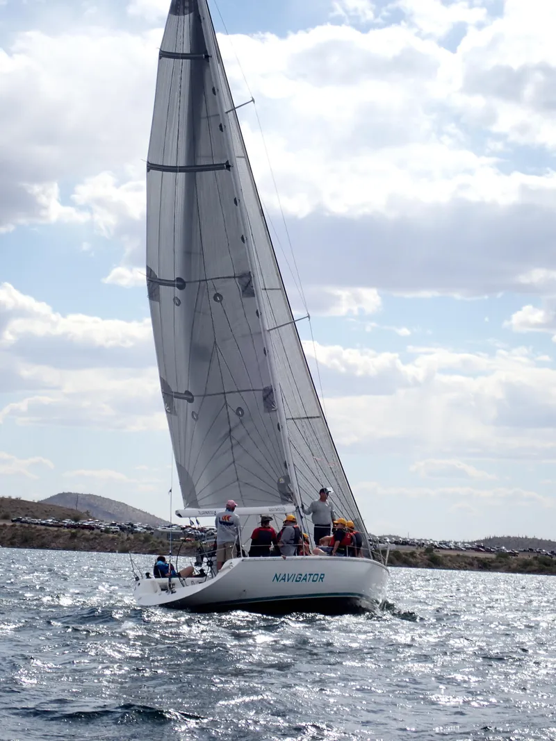 Slide: The Image of Sailboat Catalina Capri 37, 1992 model, navigating on a sunny day with crew onboard. - 19