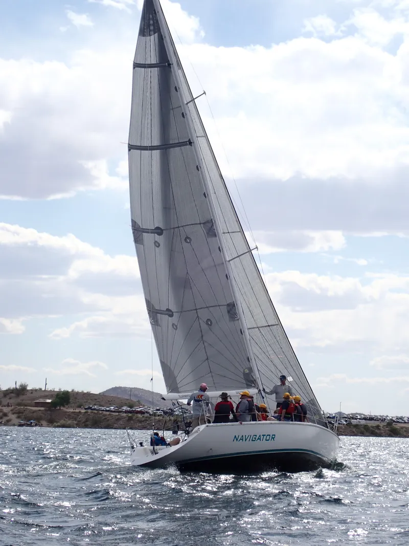 Slide: The Image of Sailing yacht Catalina Capri 37, 1992 model, with crew on open water. - 20