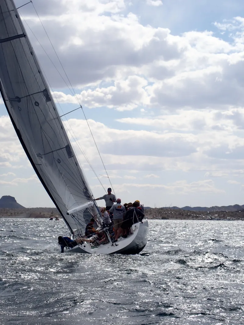 Slide: The Image of Sailboat Catalina Capri 37, 1992 model, navigating choppy waters under a cloudy sky. - 21