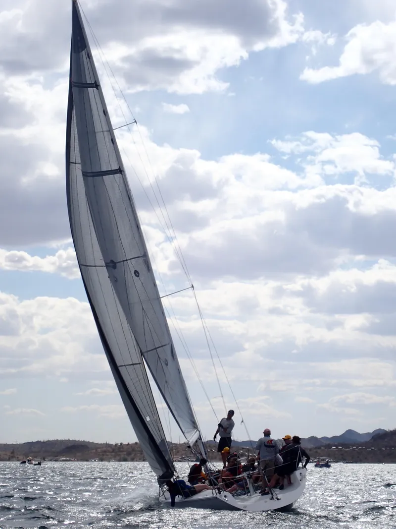 Slide: The Image of Sailboat Catalina Capri 37, 1992 model, navigating under cloudy skies on open water. - 22