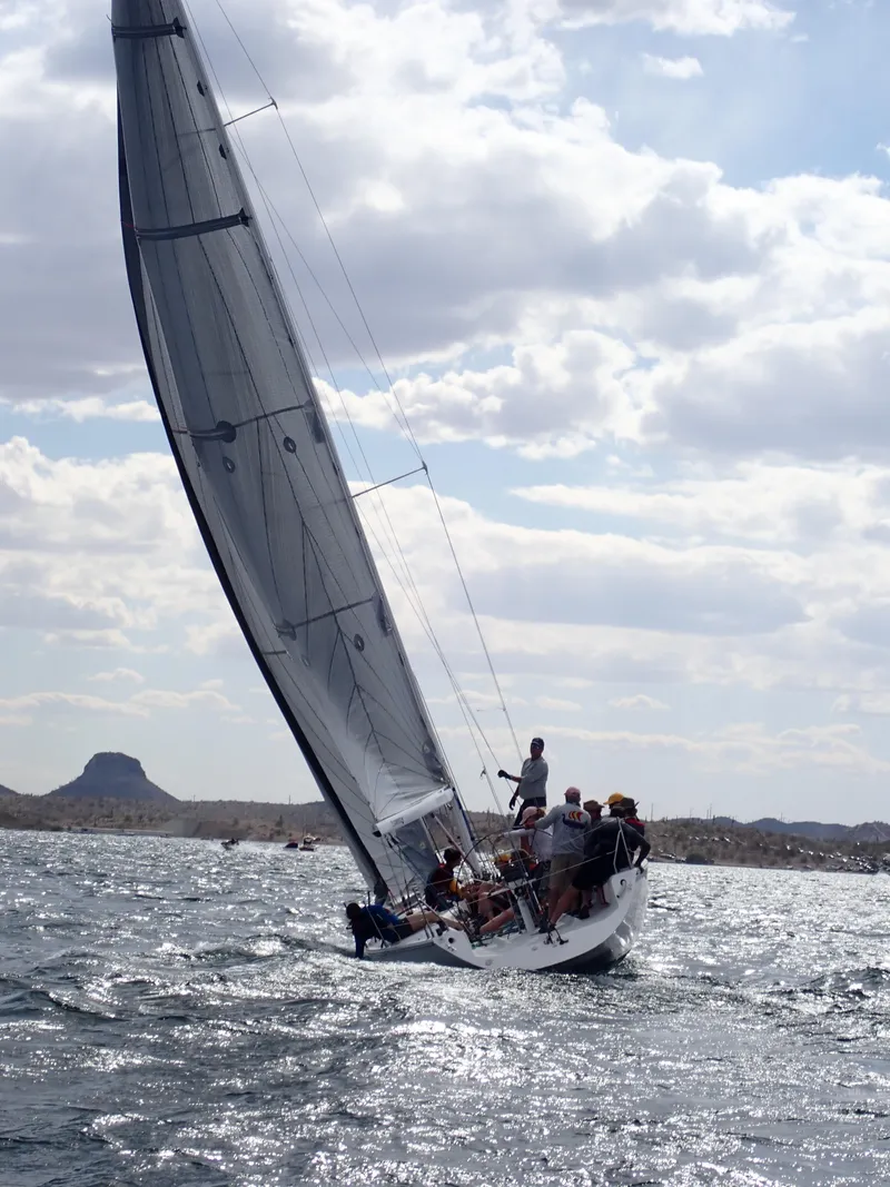 Slide: The Image of Sailboat Catalina Capri 37, 1992 model, navigating choppy waters under a cloudy sky. - 23