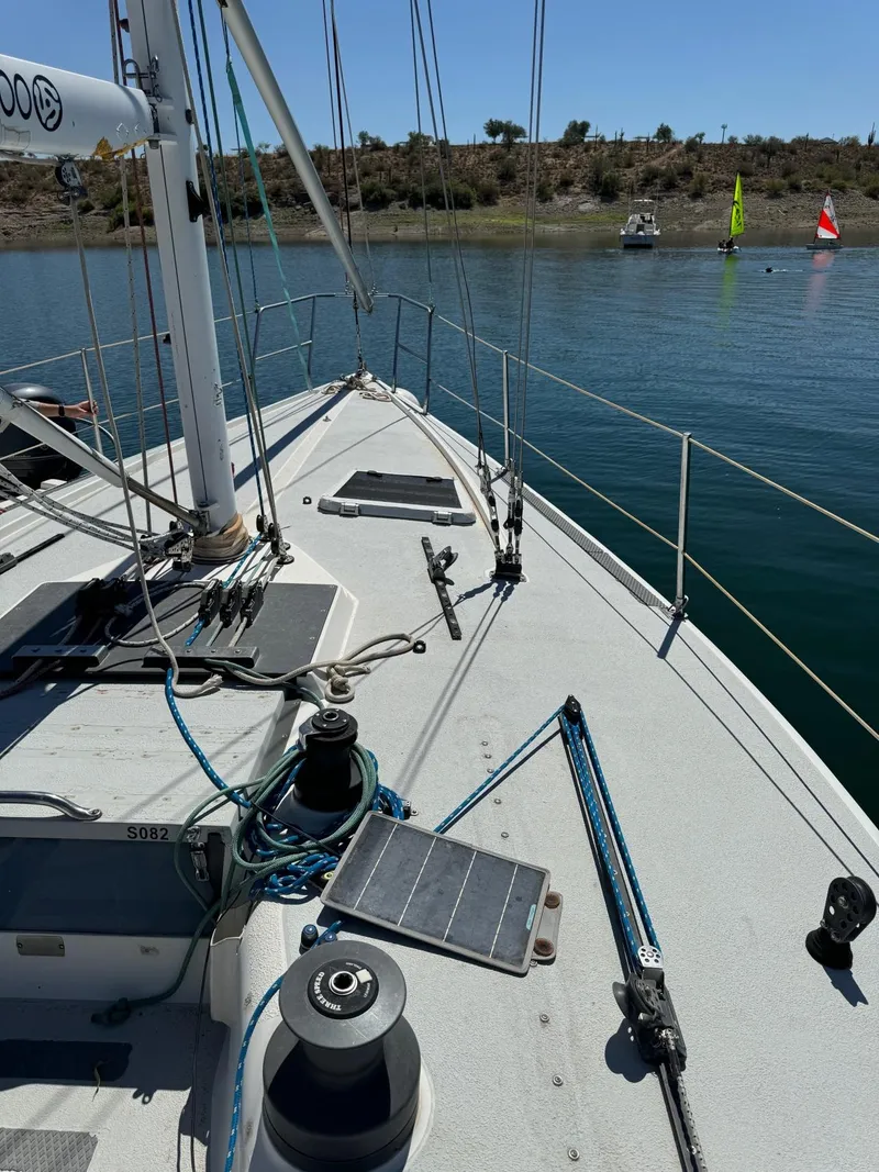 Slide: The Image of Deck view of a 1992 Catalina Capri 37 sailboat on calm water. - 25