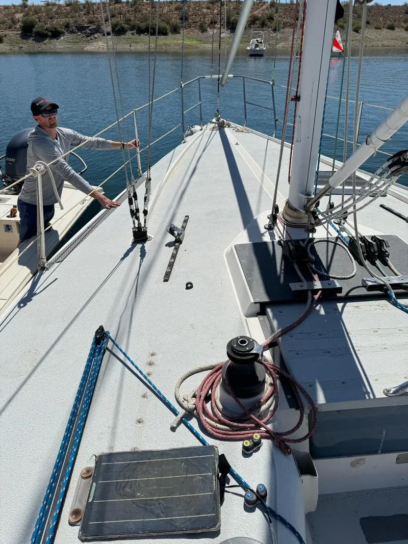 Slide: The Image of Sailboat deck of 1992 Catalina Capri 37 with person adjusting rigging. - 26