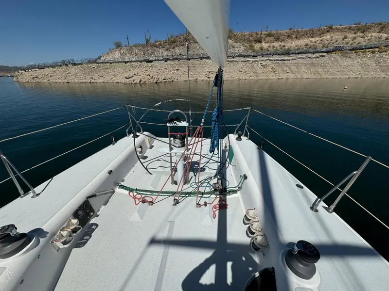 Slide: The Image of Sailboat deck view, Catalina Capri 37, 1992, on calm water near rocky shoreline. - 27