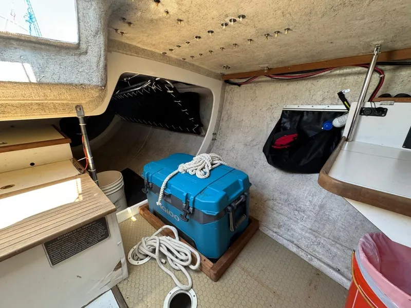 Slide: The Image of Interior of 1992 Catalina Capri 37 sailboat with blue cooler and nautical equipment. - 32