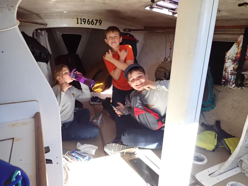 Slide: The Image of Children enjoying the cabin of a 1992 Catalina Capri 37 sailboat. - 34