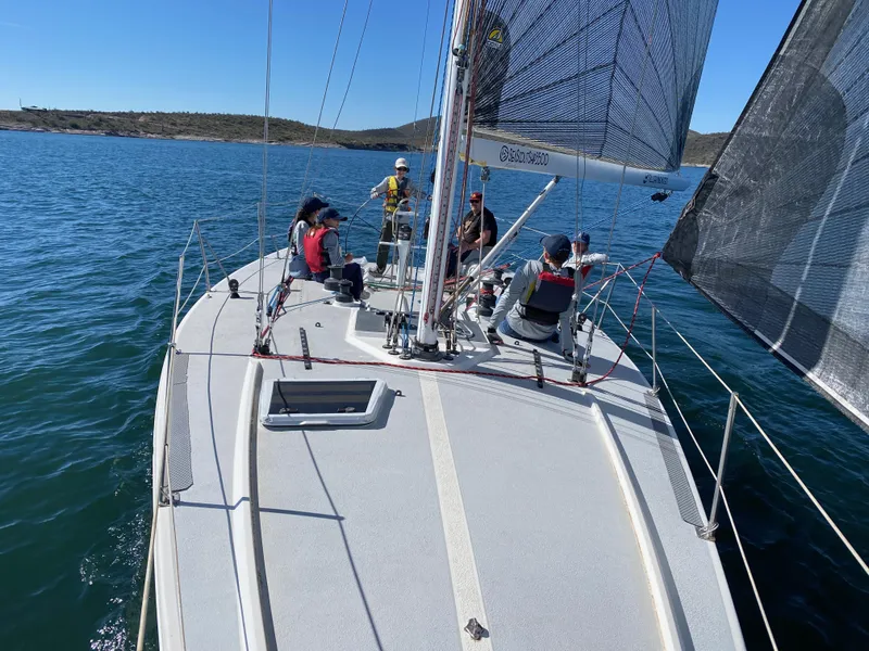 Slide: The Image of Sailors on a 1992 Catalina Capri 37 yacht navigating calm waters under clear skies. - 5