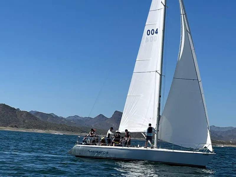 Slide: The Image of Sailboat Catalina Capri 37, 1992 model, sailing on a sunny day with crew onboard. - 6