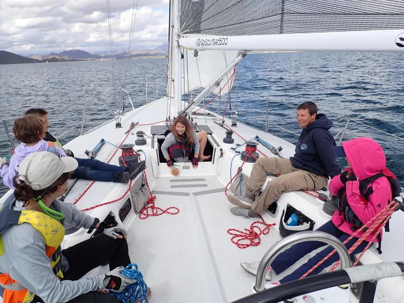 Slide: The Image of Group enjoying sailing on a 1992 Catalina Capri 37 yacht, surrounded by scenic waters. - 9