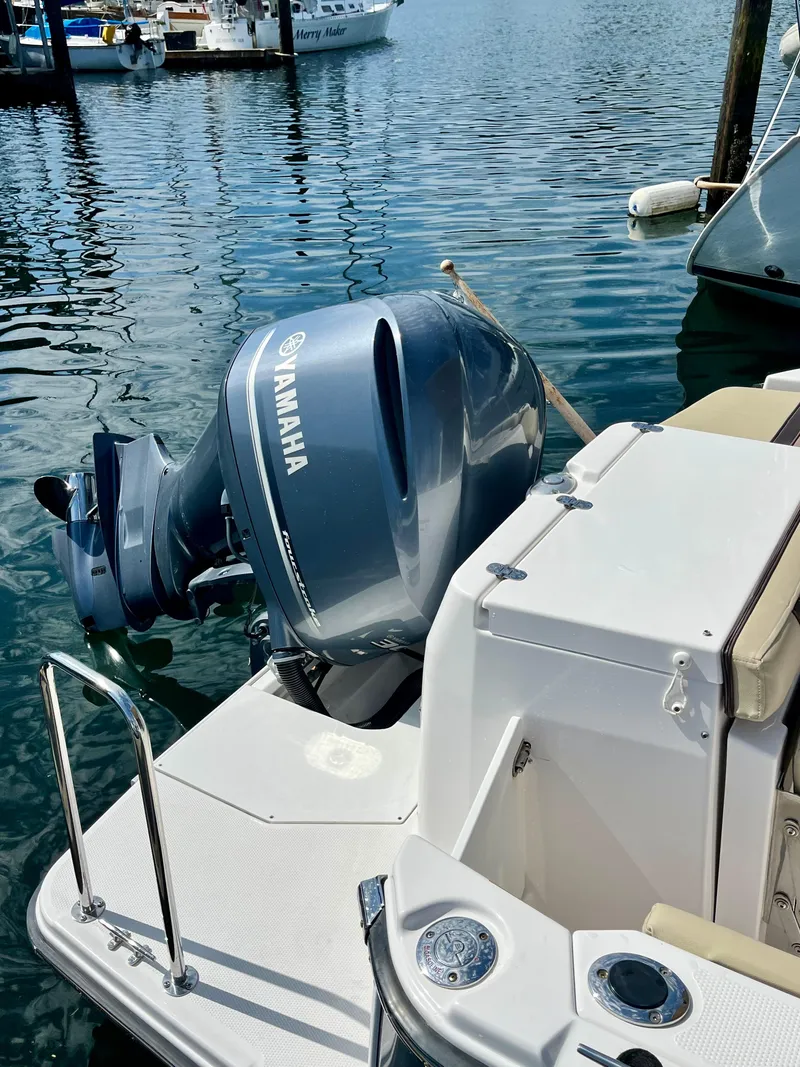 Slide: The Image of 2018 Ranger Tugs R-27 with Yamaha outboard motor docked in marina. - 13