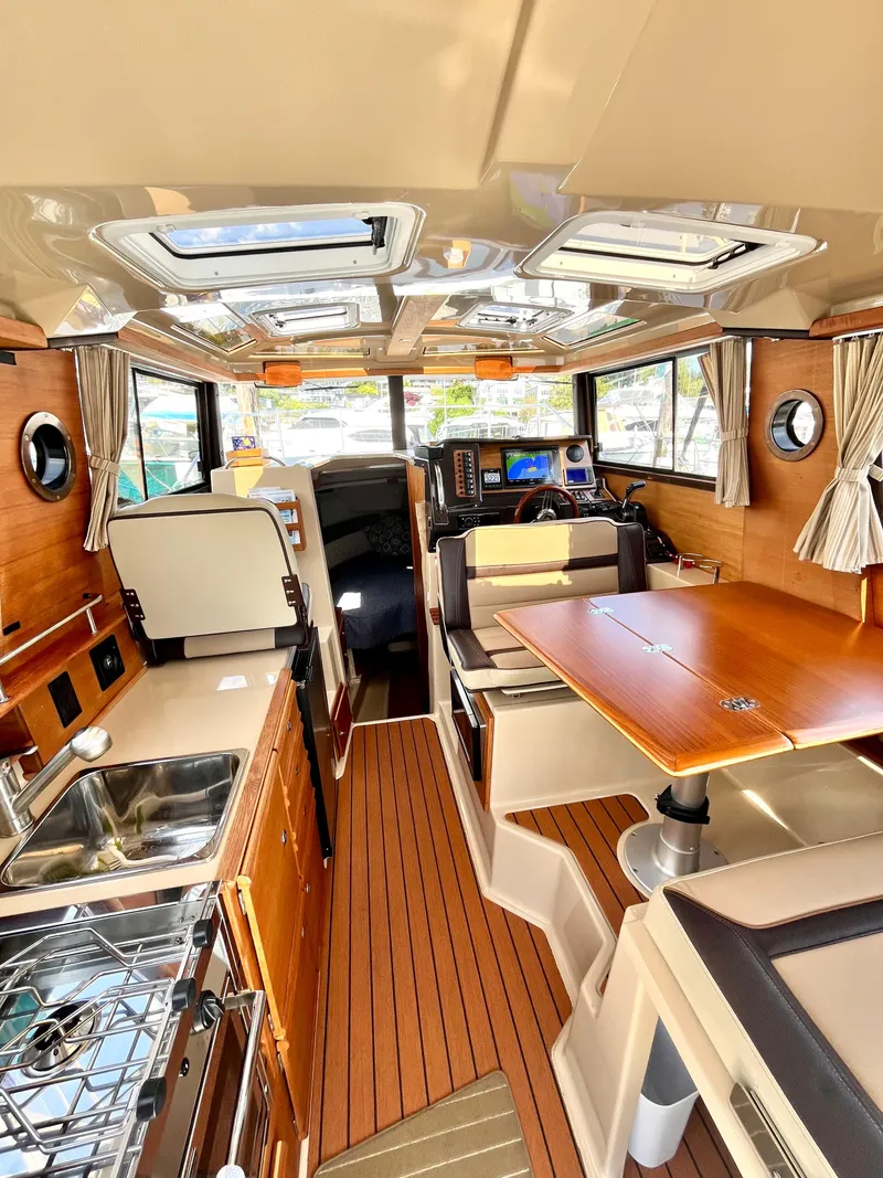 Slide: The Image of Interior of 2018 Ranger Tugs R-27 boat with wood finishes and modern amenities. - 5